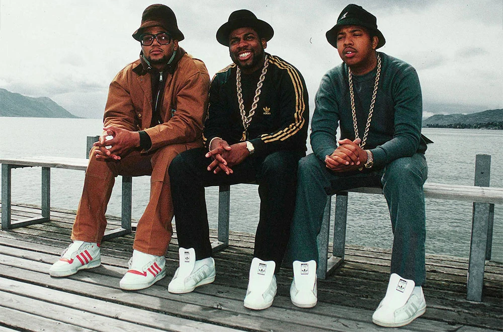 The members of RUN DMC sitting on a bench