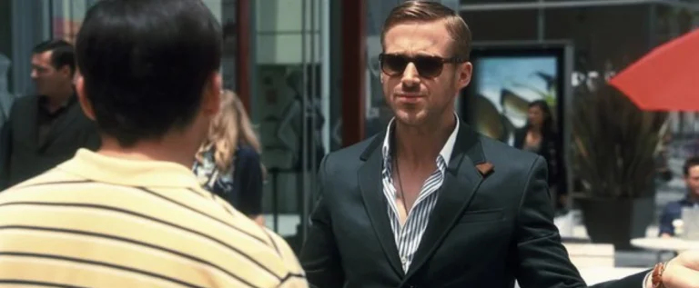 Ryan Gosling in a black suit and sunglasses